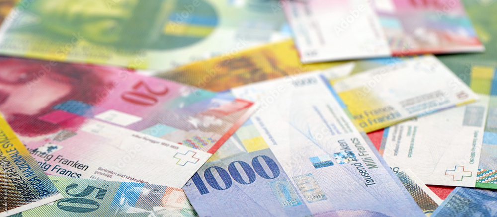 Swiss franc banknotes. The current francs money bills lies on table in big amount Swiss franc banknotes. The current francs money bills lies on table in big amount