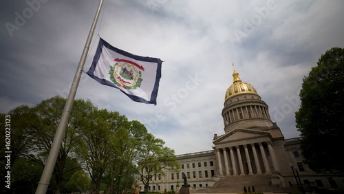 Obraz na płótnie The West Virginia State Capitol showcases its impressive dome while the state flag waves gently