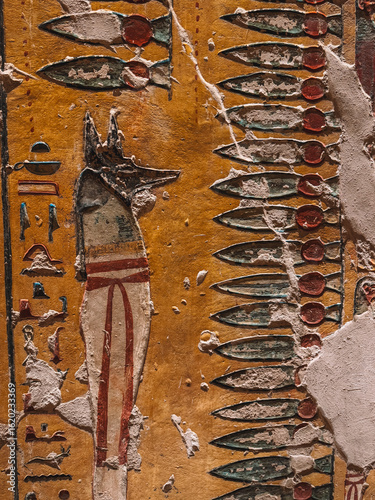 Ancient Egyptian wall with hieroglyphs and paintings