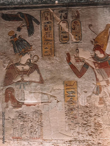 Ancient Egyptian tomb wall with colorful hieroglyphs and painted figures