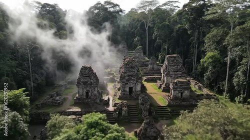 Aerial view of the ancient maya ruins of tikal in guatemala, showcasing the temples and jungle landscape with fog and mist adding to the mysterious atmosphere