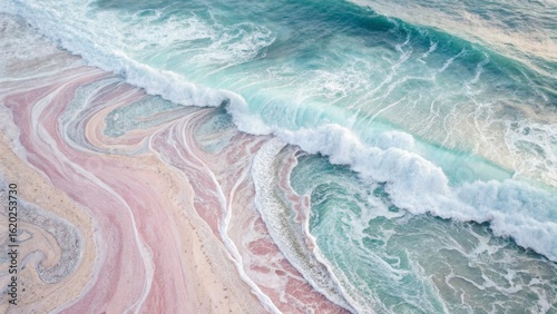 Wallpaper Mural A stunning aerial view of ocean waves rolling onto a colorful sandy beach, showcasing vibrant patterns in the water and shore. Torontodigital.ca