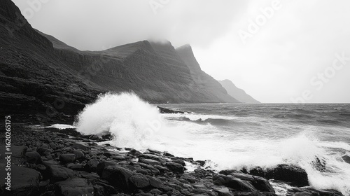 Monochrome Coastal Scene: Waves Crashing on Rocky Shore