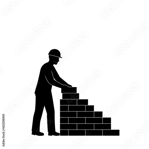 Silhouette of a construction worker building a brick wall, symbolizing hard work and development in the building industry.