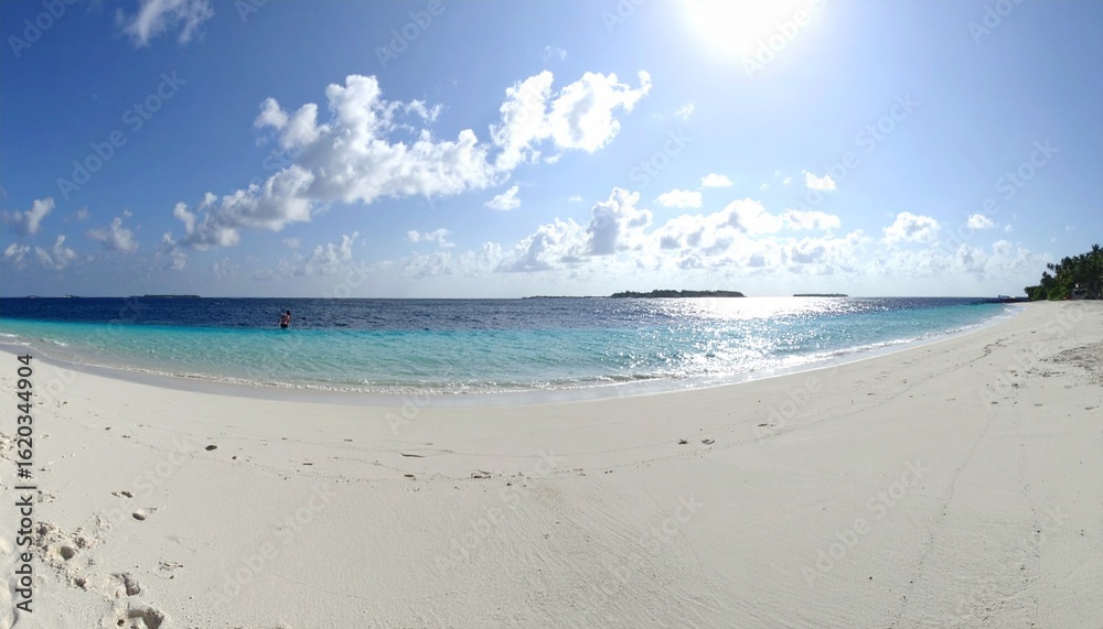 Fototapeta premium Beautiful sandy beach with white sand and rolling calm wave of turquoise ocean on Sun