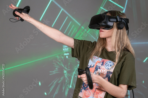 Engaging in VR Experience With Immersive Visuals and Interactive Elements. Young girl in 3D virtual reality glasses.