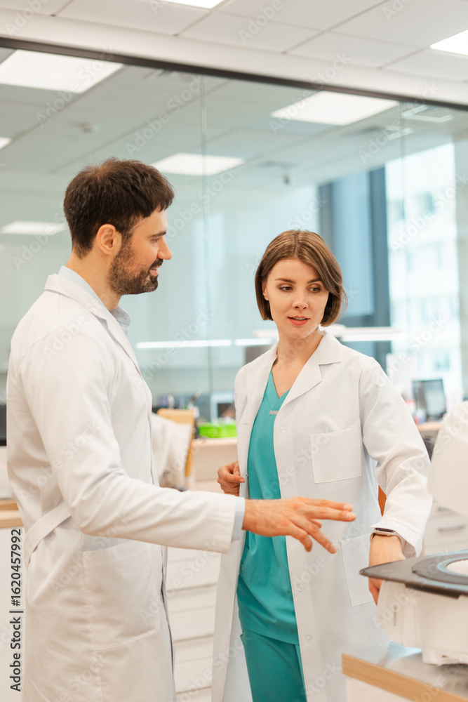 Fototapeta premium Doctors discussing medical scan results in modern hospital