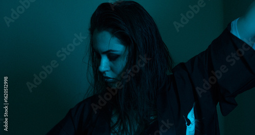 Schilderij op canvas Moody portrait of a woman in colorful lighting, emotional expression in red, blue, and teal tones