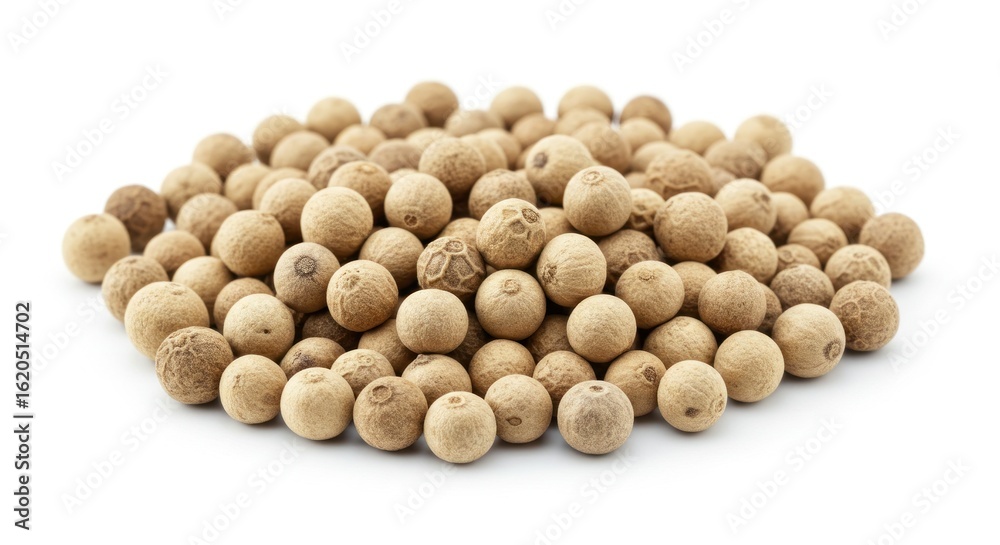 A pile of white peppercorns on a white background A pile of white peppercorns on a white background