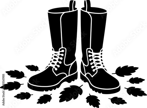 black silhouette vector of a pair of boots standing amidst scattered autumn leaves