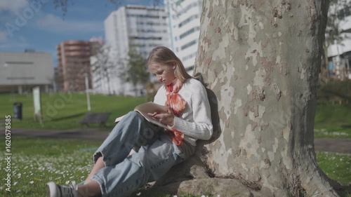 Peaceful student enjoying reading in a urban park