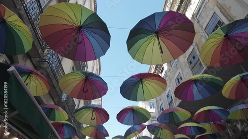 Colorful rainbow umbrellas hanging over a street in Lisbon