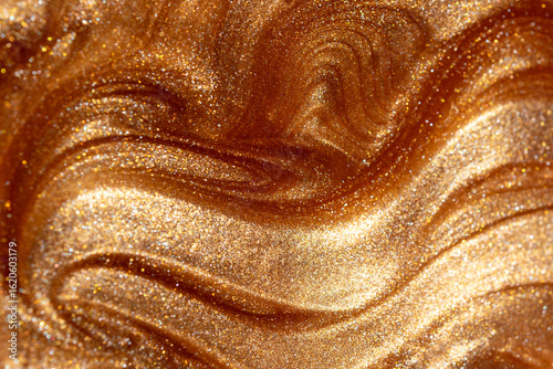 Glowing golden shimmering cosmetic texture of gel or body spray. Background texture for backdrops or mapping.