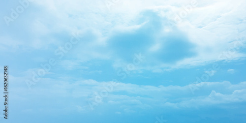 Cloudy blue summer storm  in the sky, watercolor background, horizontal view, beautiful cloudscape, fresh air, nature shining light, sunrise sky, panoramic view, daylight, vast fluffy tiny white sunsh
