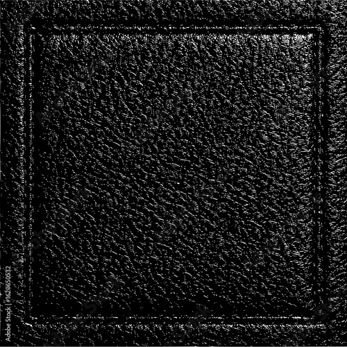 Close up of dark textured surface with a rectangular recessed border creating a framed effect in black