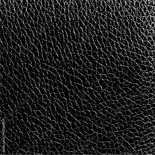 Close up of a black leather texture with a pattern of small cracks and lines in a dark background
