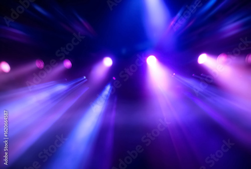 Vibrant blue and purple spotlights on dark stage. Dynamic lighting setup for concert banners or performance visuals