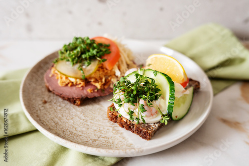 Photography Smorrebrod, traditional Danish open-faced sandwiches with roast beef and shrimps on a plate
