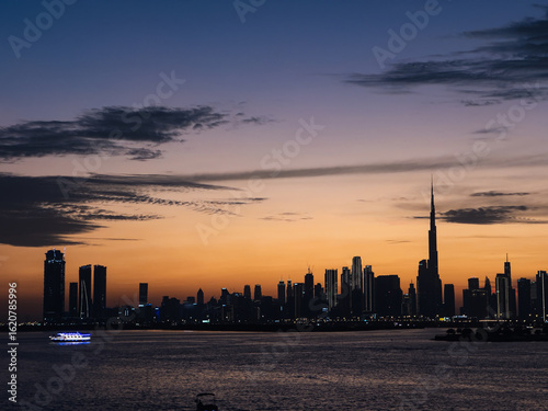 Cinematic Dubai Skyline at Twilight with Boats on Creek

