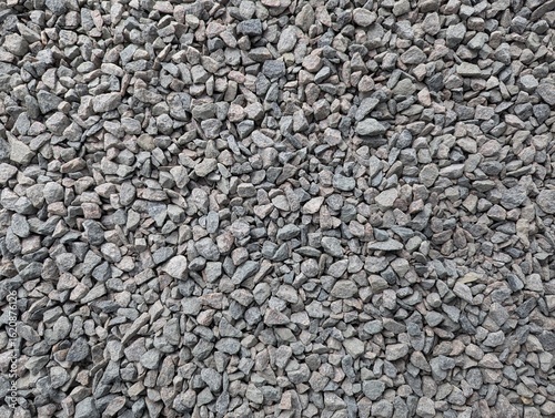 Granite gravel scattered on the ground creates a textured surface that invites exploration and imagination in a construction site