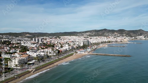 Wallpaper Mural Aerial view of the Spanish coastline with white buildings contrasting against the turquoise sea and sandy beach, Sitges, Barcelona, Spain. Torontodigital.ca