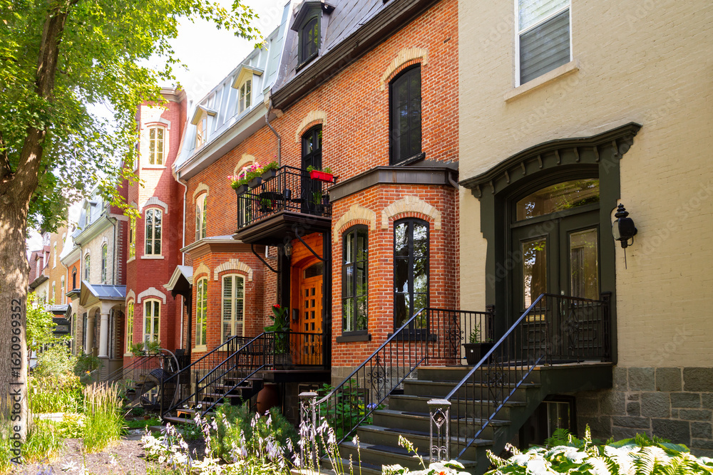 Naklejka premium Row of 19th Century brick houses in the Second Empire style located in the Montcalm area, with ornate front doors topped by classical wooden pediments, Quebec City, Québec, Canada