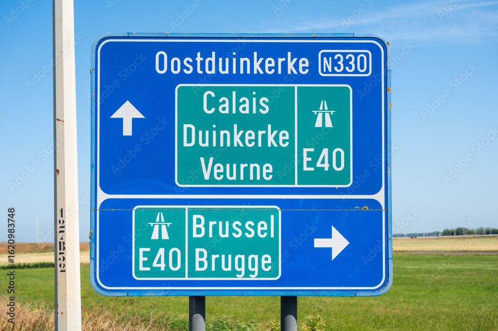 Fototapeta premium Road sign to Oostduinkerke and the E 40 highway in Avekapelle, Veurne, Belgium