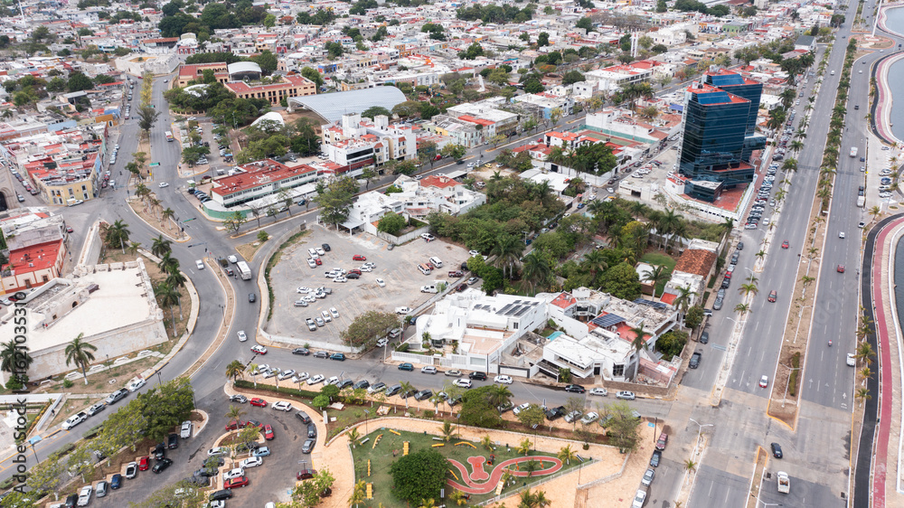 Naklejka premium Palm trees frame buildings of downtown Campeche, Mexico.