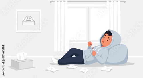 Ill Young Man Lying On The Floor Feeling Unwell Holding Thermometer