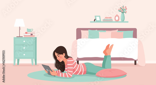 Girl relaxing with tablet on rug in bedroom, enjoying leisure time at home