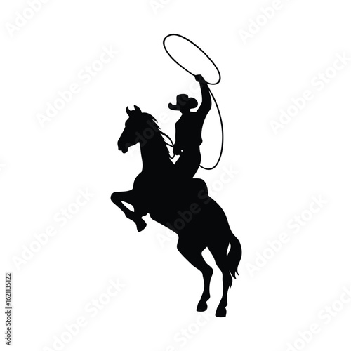 Silhouette of a cowboy on a bucking horse with a lasso