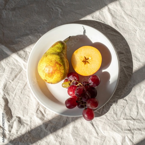 Fruits with Grapes Apple and Pear on White Plate Under Natural Sunlight