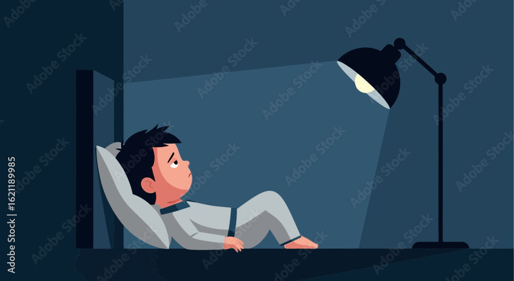 Fototapeta premium Boy Lying Awake Under Lamp During Night Suffering From Insomnia