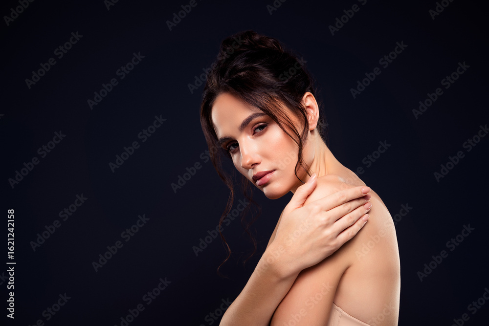 Portrait of a Young Brunette Woman with Bare Shoulders on a Dark Background, Showcasing Elegance Portrait of a Young Brunette Woman with Bare Shoulders on a Dark Background, Showcasing Elegance