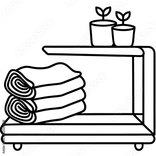 Neatly folded towels in soft colors, arranged on a wooden shelf with a small soap dish and a dried flower.