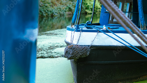 Fotografie Vintage boats moored on calm canal water in charming English Little Venice town