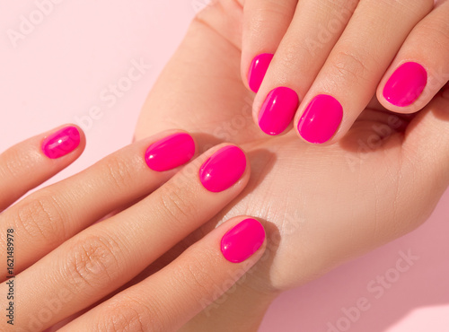 Close up beautiful womans hands with pink nail design. Manicure, pedicure beauty salon concept