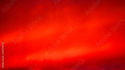 Dramatic sunset over the Green Mountains in Rutland, Vermont, USA, with blazing red and orange clouds lighting up the sky after a refreshing summer rain.