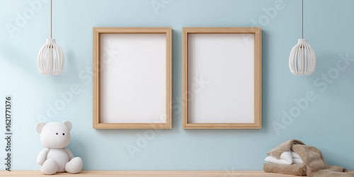 Two wooden picture frames with blank white spaces hang on light blue wall, flanked by modern pendant lights. plush teddy bear and folded towels rest on wooden shelf, creating cozy atmosphere