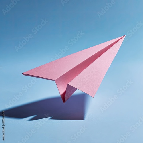 Wallpaper Mural Pink paper airplane against a light blue backdrop.  Torontodigital.ca