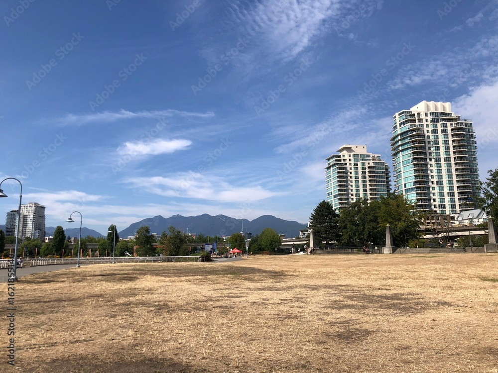 Fototapeta premium View of North Shore Mountains from Park Near Science World, Vancouver on a Sunny Summer Day