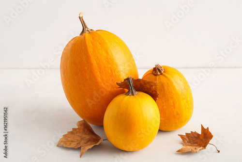 Raw pumpkins and dry leaves...