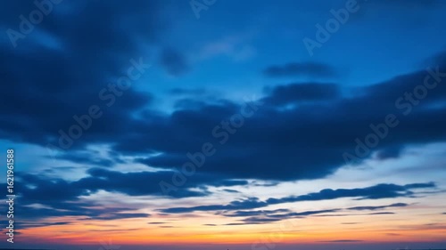 Dramatic Sunset Sky with Dark Clouds and Vibrant Orange and Blue Hues