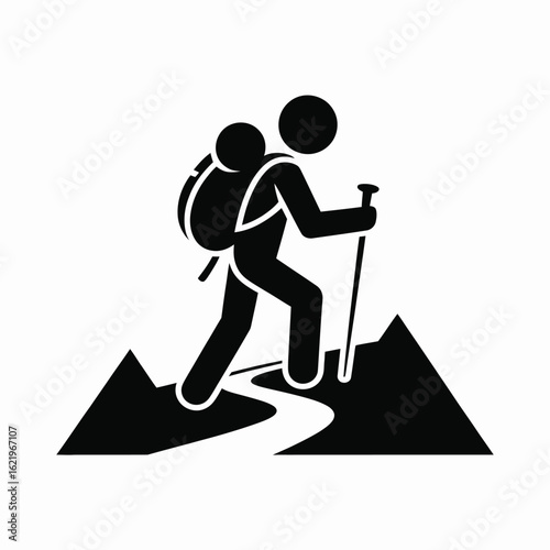 Silhouette of a hiker with a backpack and trekking pole on a mountain path