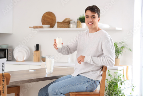Young man with glass of mil...
