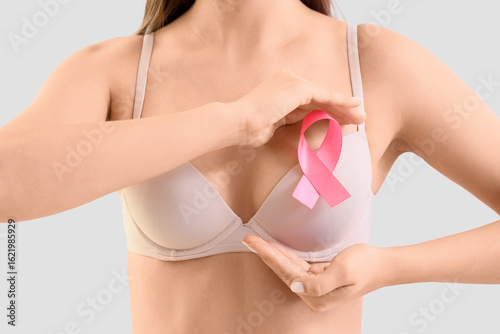 Young woman in bra with pin...