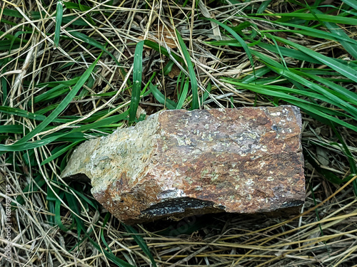 Close-up shot of a textured rock surface showcasing earthy tones of brown, red, and gray