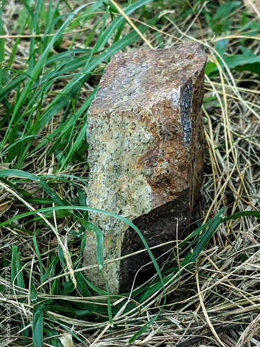 Close-up shot of a textured rock surface showcasing earthy tones of brown, red, and gray