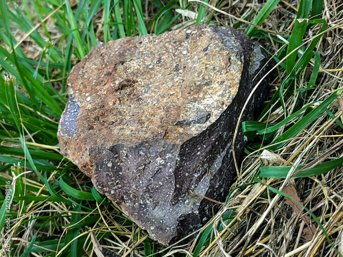 Close-up shot of a textured rock surface showcasing earthy tones of brown, red, and gray
