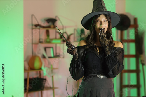 Surprised young witch with ...